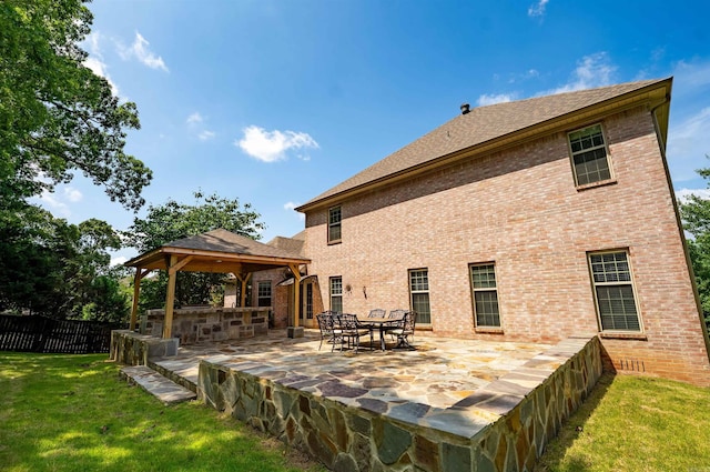 22 Jacob Pl, Little Rock, AR 72211 - back of property featuring a gazebo, a patio area, brick siding, and a shingled roof