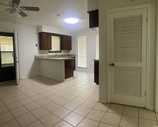 9425 Labette Dr, Little Rock, AR 72205 - kitchen with a peninsula, ceiling fan, light tile patterned floors, and dark brown cabinetry