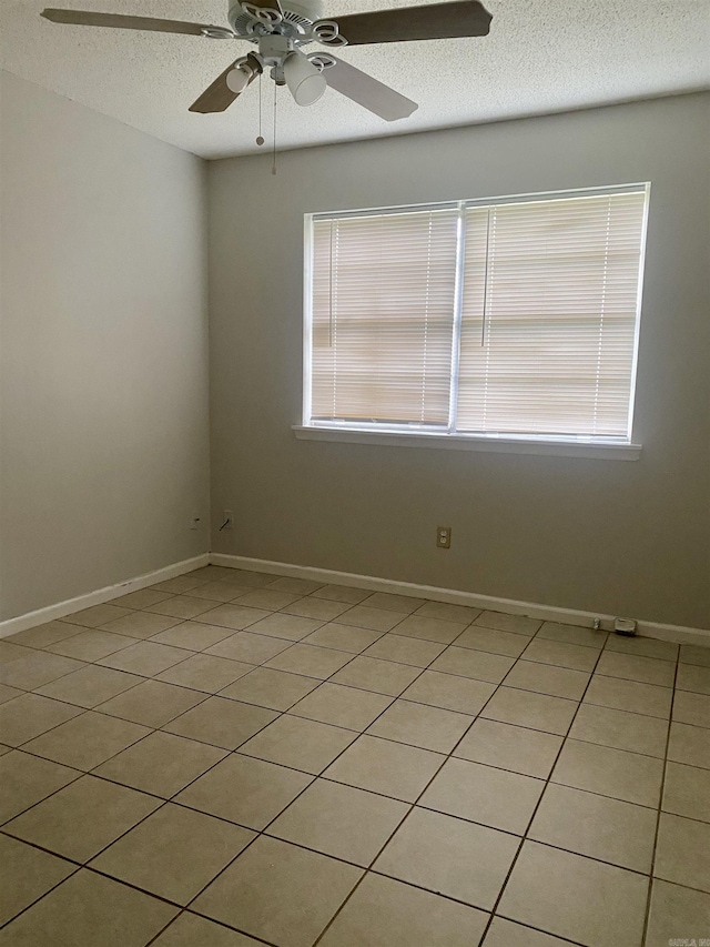9425 Labette Dr, Little Rock, AR 72205 - unfurnished room featuring a textured ceiling, ceiling fan, and light tile patterned floors