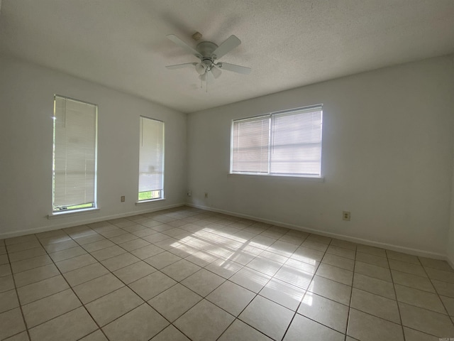9425 Labette Dr, Little Rock, AR 72205 - spare room with light tile patterned floors, ceiling fan, and a textured ceiling
