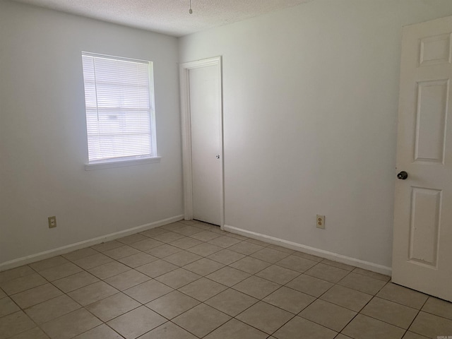 9425 Labette Dr, Little Rock, AR 72205 - unfurnished room with a textured ceiling and light tile patterned flooring