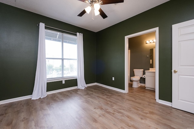 800 N St Unit 48, Little Rock, AR 72201 - unfurnished bedroom featuring light wood-style floors, ensuite bath, and a ceiling fan