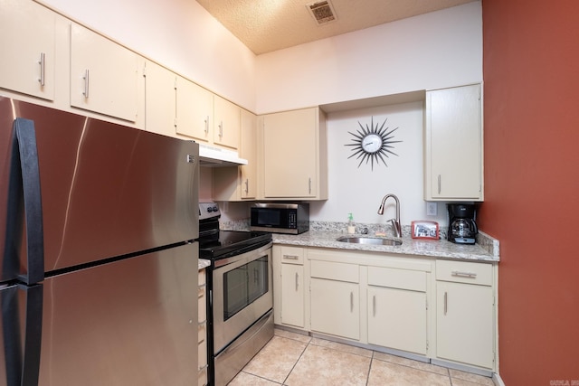 800 N St Unit 48, Little Rock, AR 72201 - kitchen featuring stainless steel appliances, under cabinet range hood, and light tile patterned flooring