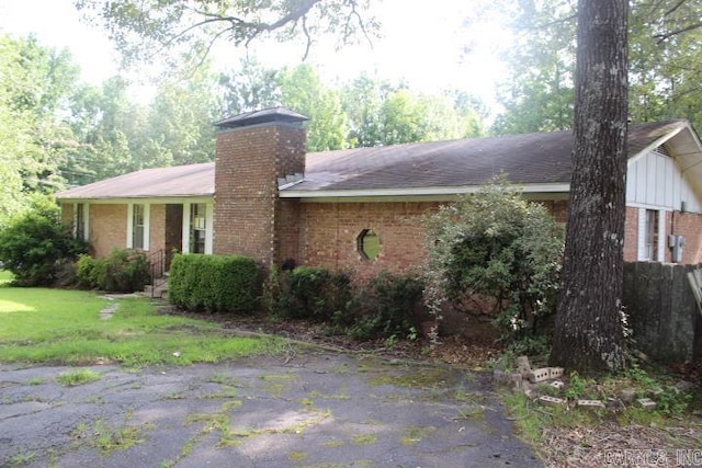 22213 N Springlake Rd, Hensley, AR 72065 - view of front facade featuring brick siding and a chimney