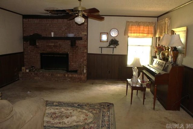 22213 N Springlake Rd, Hensley, AR 72065 - carpeted living room with wainscoting, a ceiling fan, a brick fireplace, ornamental molding, and a textured ceiling