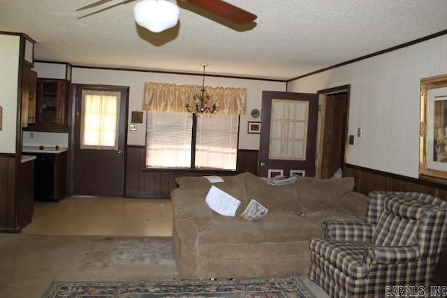 22213 N Springlake Rd, Hensley, AR 72065 - living room featuring wainscoting, a textured ceiling, a ceiling fan, wood walls, and ornamental molding