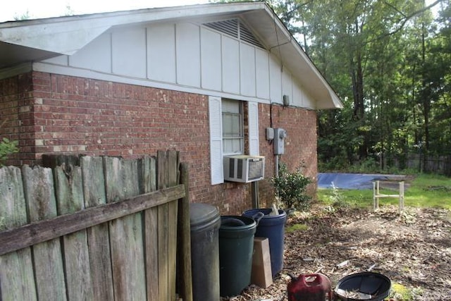22213 N Springlake Rd, Hensley, AR 72065 - view of property exterior with brick siding, board and batten siding, and cooling unit