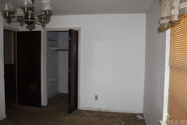 22213 N Springlake Rd, Hensley, AR 72065 - unfurnished bedroom featuring a chandelier, a spacious closet, and a closet