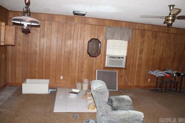 22213 N Springlake Rd, Hensley, AR 72065 - living area with carpet floors, a ceiling fan, wooden walls, cooling unit, and a textured ceiling