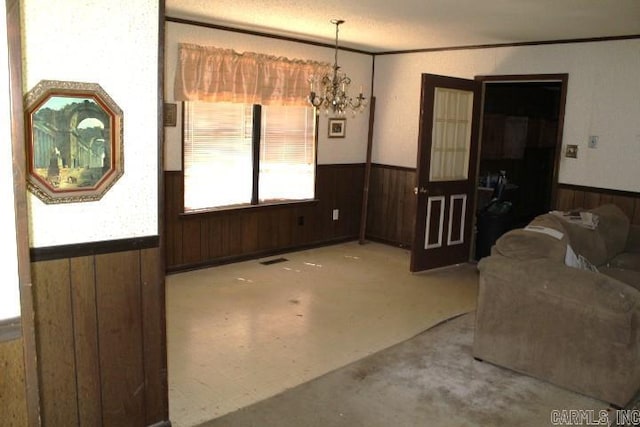 22213 N Springlake Rd, Hensley, AR 72065 - dining area featuring wainscoting, wooden walls, a chandelier, and ornamental molding