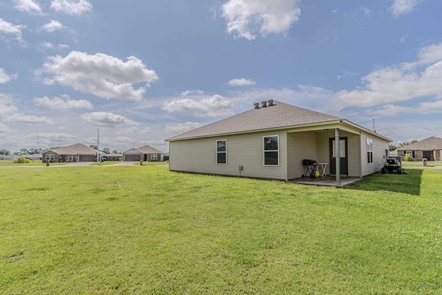 5244 Prospect Trl, Jonesboro, AR 72405 - back of house featuring a patio area, a yard, and a shingled roof