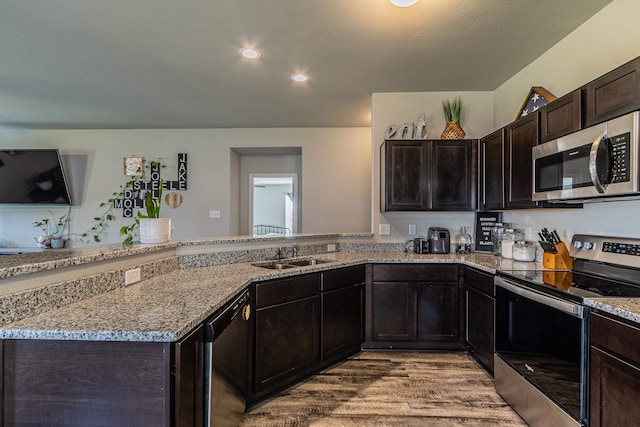 5244 Prospect Trl, Jonesboro, AR 72405 - kitchen with stainless steel appliances, light wood-style flooring, light stone countertops, a peninsula, and recessed lighting