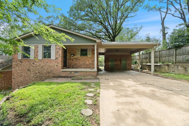 1112 N Hughes St, Little Rock, AR 72007 - view of front of house featuring brick siding, concrete driveway, covered porch, and a carport