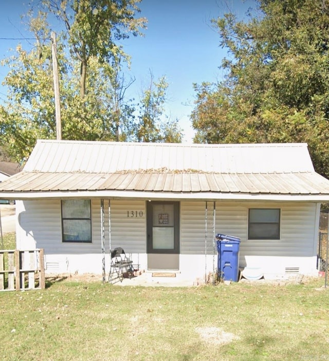 1310 Jones, Corning, AR 72422 - view of front of house featuring a front lawn, a porch, and a metal roof