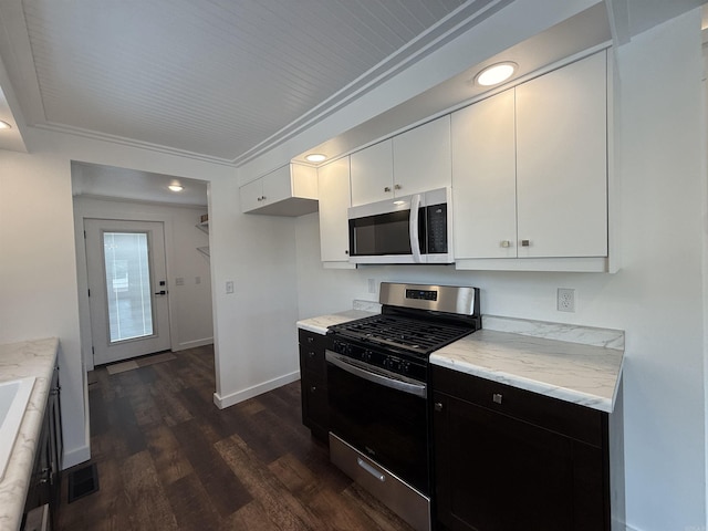 219 N Chestnut St, Harrison, AR 72601 - kitchen featuring stainless steel appliances, dark wood-style floors, white cabinets, dark cabinetry, and recessed lighting