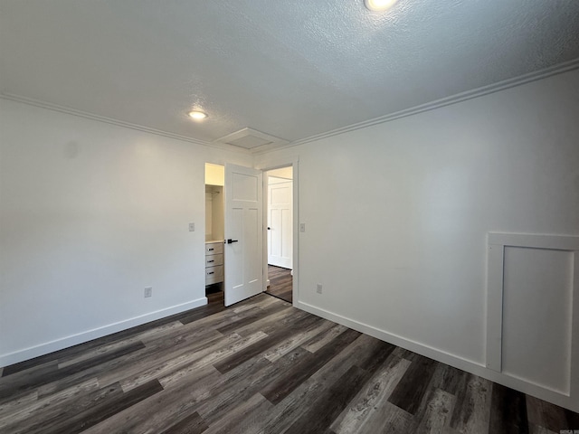 219 N Chestnut St, Harrison, AR 72601 - spare room featuring a textured ceiling, attic access, dark wood finished floors, crown molding, and recessed lighting