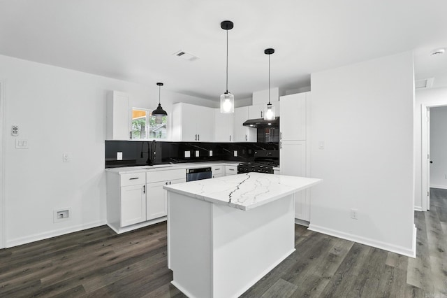 43 S Wakefield Dr, Little Rock, AR 72209 - kitchen featuring under cabinet range hood, dark wood finished floors, decorative backsplash, white cabinets, and a kitchen island