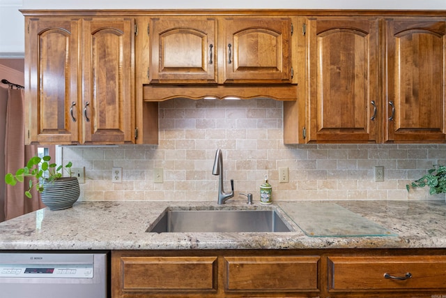 2608 Grist Mill Rd, Little Rock, AR 72227 - kitchen featuring white dishwasher, decorative backsplash, light stone countertops, and brown cabinets