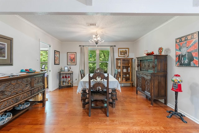 2608 Grist Mill Rd, Little Rock, AR 72227 - dining area featuring a chandelier, light wood finished floors, ornamental molding, and a textured ceiling