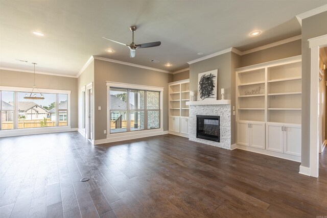 2690 Overcup Dr, Conway, AR 72034 - unfurnished living room with ceiling fan, a stone fireplace, dark wood-type flooring, ornamental molding, and a chandelier