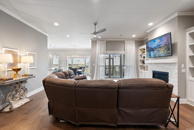 2690 Overcup Dr, Conway, AR 72034 - living room with crown molding, a ceiling fan, a stone fireplace, recessed lighting, and dark wood-style flooring