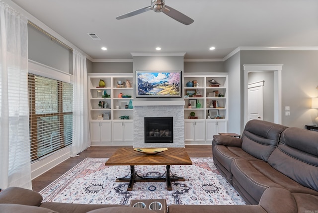 2690 Overcup Dr, Conway, AR 72034 - living room featuring crown molding, a ceiling fan, wood finished floors, a glass covered fireplace, and recessed lighting