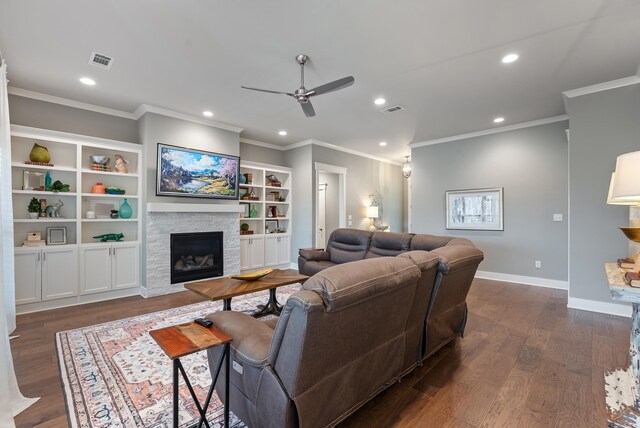 2690 Overcup Dr, Conway, AR 72034 - living room featuring a fireplace, recessed lighting, a ceiling fan, crown molding, and dark wood-style flooring
