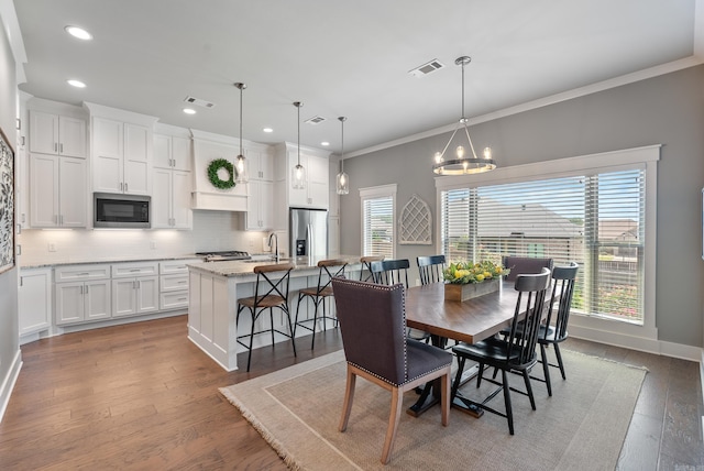 2690 Overcup Dr, Conway, AR 72034 - dining space with recessed lighting, wood finished floors, crown molding, and a chandelier