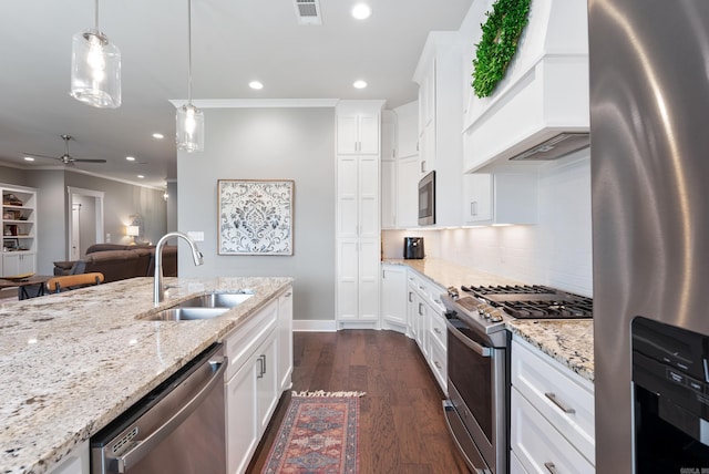 2690 Overcup Dr, Conway, AR 72034 - kitchen featuring appliances with stainless steel finishes, crown molding, custom range hood, open floor plan, and recessed lighting