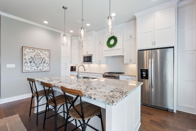 2690 Overcup Dr, Conway, AR 72034 - kitchen with stainless steel appliances, white cabinetry, a center island with sink, a kitchen breakfast bar, and recessed lighting