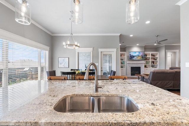 2690 Overcup Dr, Conway, AR 72034 - kitchen with ornamental molding, pendant lighting, open floor plan, ceiling fan, and light stone counters