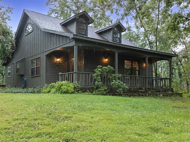 16 Almenara, Hot Springs Village, AR 71909 - view of side of property featuring covered porch, a lawn, and a shingled roof