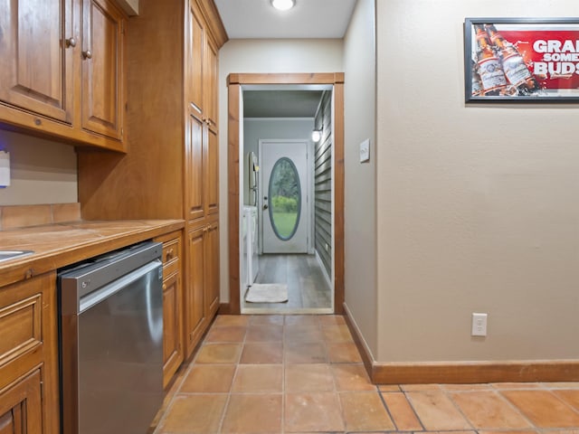 16 Almenara, Hot Springs Village, AR 71909 - kitchen with stainless steel dishwasher, brown cabinetry, tile countertops, and light tile patterned floors