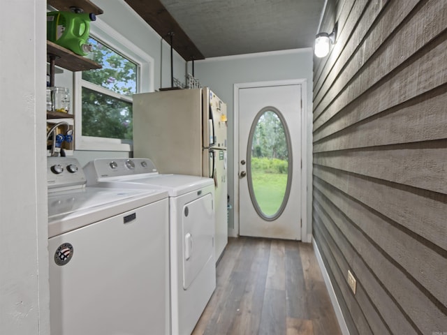 16 Almenara, Hot Springs Village, AR 71909 - washroom featuring washer and dryer, hardwood / wood-style flooring, and wooden walls