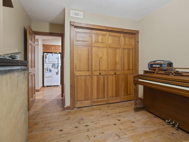 16 Almenara, Hot Springs Village, AR 71909 - bedroom with freestanding refrigerator and light wood-style flooring