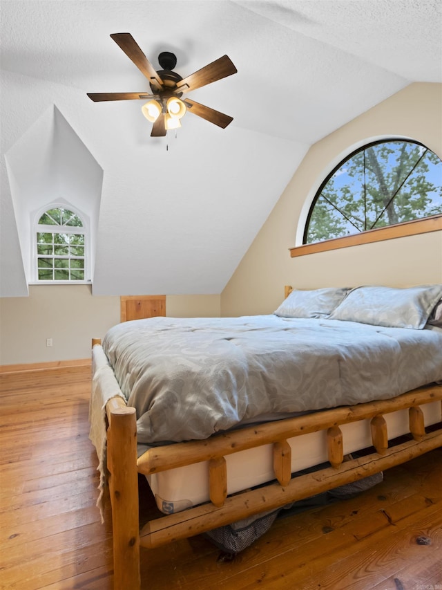 16 Almenara, Hot Springs Village, AR 71909 - bedroom featuring lofted ceiling, hardwood / wood-style flooring, ceiling fan, and a textured ceiling