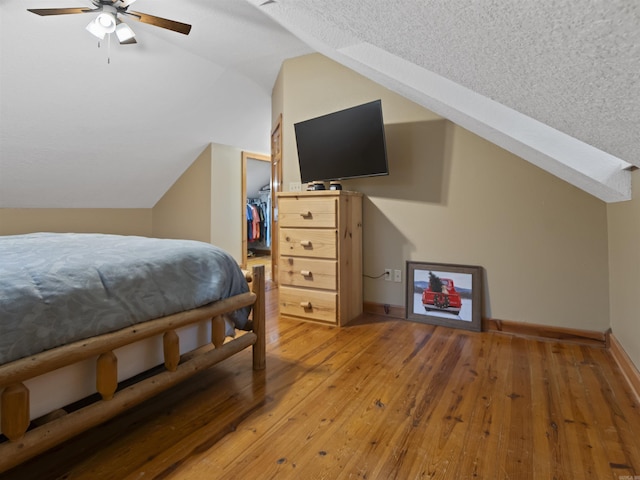 16 Almenara, Hot Springs Village, AR 71909 - bedroom featuring vaulted ceiling, light wood-style flooring, a spacious closet, ceiling fan, and a closet