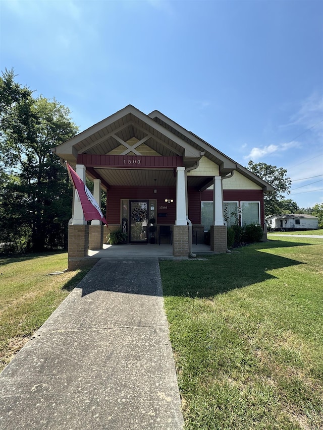 1500 Valmar St, Little Rock, AR 72204 - view of front facade with brick siding, a front yard, and covered porch