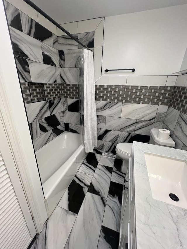1824 N Hughes St, Little Rock, AR 72207 - full bathroom with vanity, shower / bath combo, tile walls, and marble finish floors