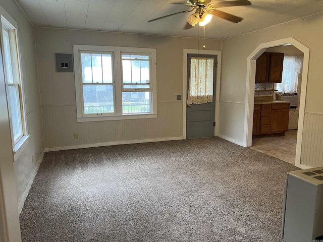 418 N Robinson St, Harrison, AR 72601 - unfurnished living room with a ceiling fan, carpet floors, electric panel, and wainscoting
