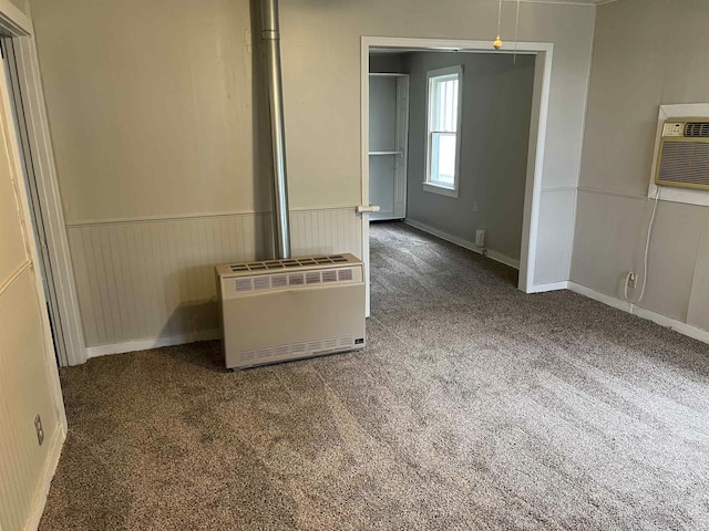 418 N Robinson St, Harrison, AR 72601 - unfurnished living room with heating unit, wainscoting, carpet, and a wall mounted air conditioner