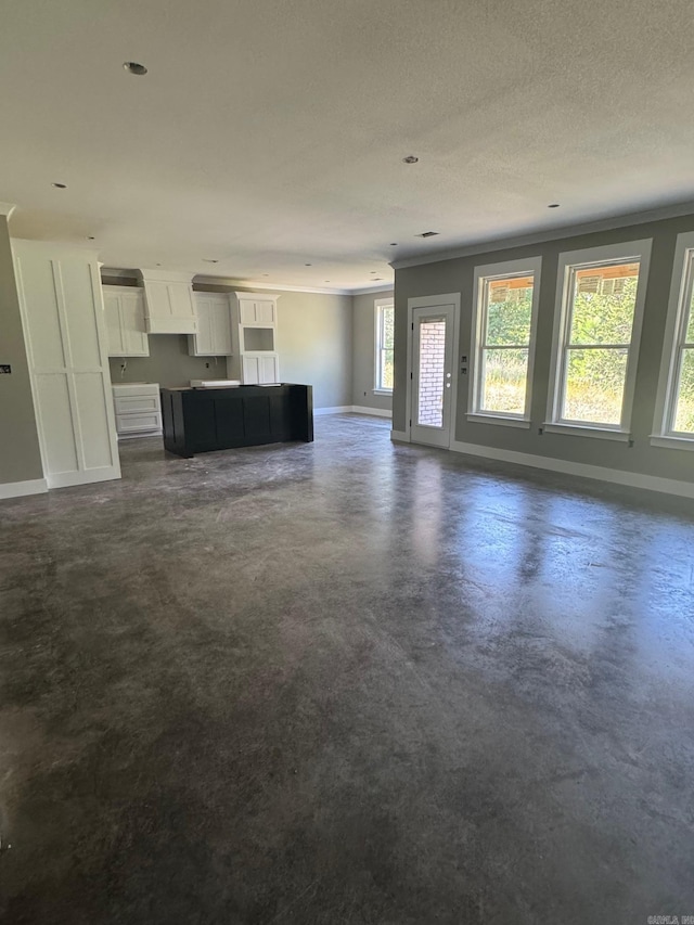5 Ridge View St, Vilonia, AR 72173 - unfurnished living room featuring concrete floors and a textured ceiling