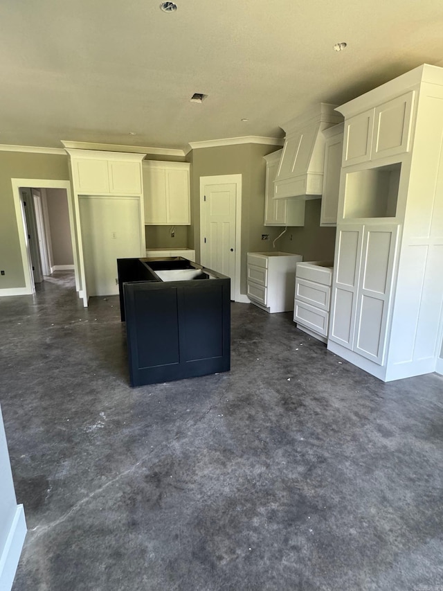 5 Ridge View St, Vilonia, AR 72173 - kitchen featuring ornamental molding, a center island, white cabinetry, and concrete flooring