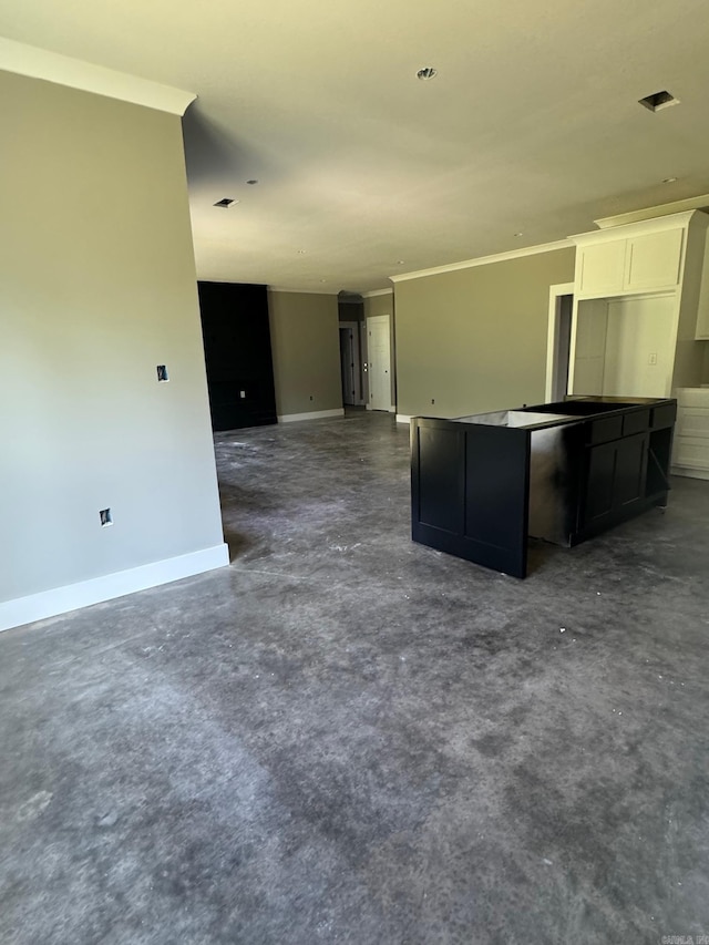 5 Ridge View St, Vilonia, AR 72173 - kitchen featuring finished concrete flooring, white cabinetry, open floor plan, ornamental molding, and a kitchen island