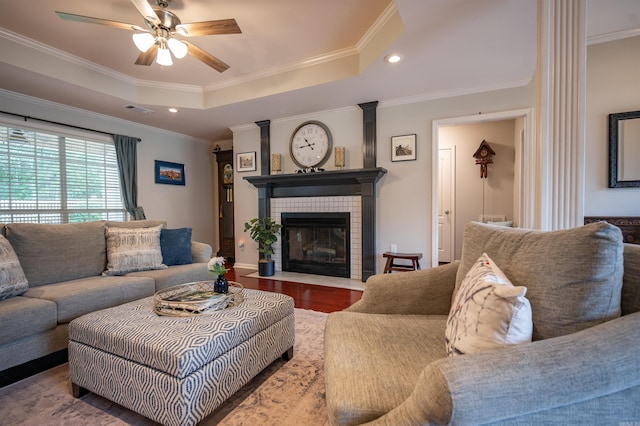 7139 Park Meadows Dr, Sherwood, AR 72120 - living area featuring ceiling fan, a tiled fireplace, crown molding, recessed lighting, and a tray ceiling