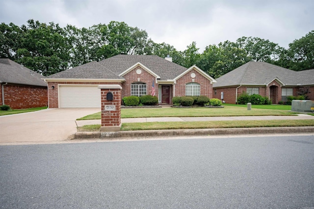 7139 Park Meadows Dr, Sherwood, AR 72120 - ranch-style home with brick siding, a garage, a front yard, and driveway