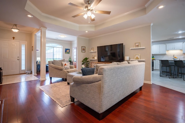 7139 Park Meadows Dr, Sherwood, AR 72120 - living area with decorative columns, a raised ceiling, dark wood-style flooring, a ceiling fan, and recessed lighting