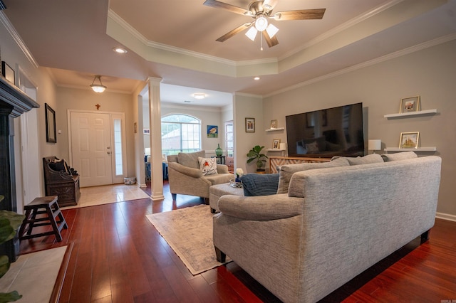 7139 Park Meadows Dr, Sherwood, AR 72120 - living room with ornate columns, dark wood finished floors, a ceiling fan, a tray ceiling, and ornamental molding