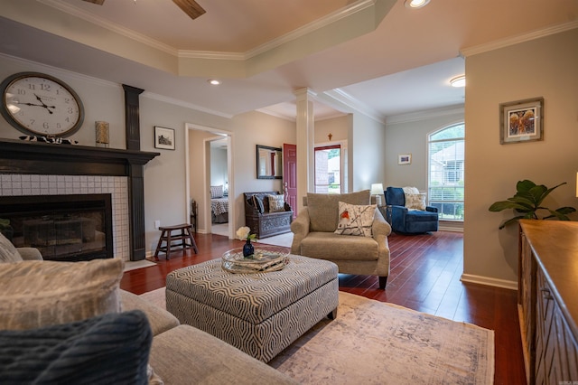 7139 Park Meadows Dr, Sherwood, AR 72120 - living area featuring dark wood-style flooring, ornamental molding, ornate columns, a fireplace, and a ceiling fan