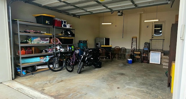 795 S Hill Dr, Jonesboro, AR 72401 - garage featuring fridge with ice dispenser and a garage door opener